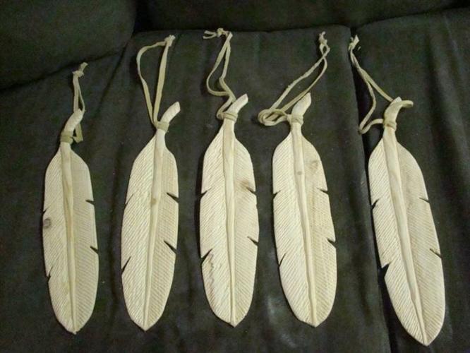 Carved wooden feathers