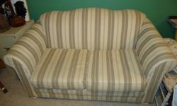 It is off white with green stripes. Two person Couch. Depth is 36 inches. Width is 65 inches from the arm rests. Height is 35 inches from the highest point.