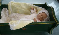 very cute 12" sleepy LB Baby Doll with Christening Gown and green solid wooden Cradle, a very nice toy for a little Girl, the Baby Doll has a soft Body, the Head, legs and arms are vinel material, the Doll is in good condition, Cradle could use a tuch up