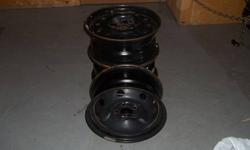 set of 4 15 in black steel rims for ford taurus.  used one winter.