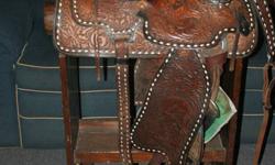 Quality 16" western saddle, with breast collar, rear girth, pad, bridle and reins. In very good condition. Beautifully hand tooled. Full Quarter Horse bars. Serious only inquires please. Call Tom at 882-0958