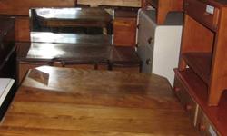 solid wood table with hidden leaf underneath with 4 chairs and a captains chair