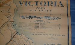 1950 Map of Victoria printed in 1953 by Island Blue Print 718 View St.  This is approx 40"l x 43"w and hangs between two black half-dowels.  Some rips and wear/tears.  Used by a feed store for its 'rural' deliveries with street index across the bottom.