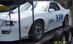 This is a race prepared IROC Camaro. GM produced  these cars in 1988 for a racing series called the Players Challenge Series. They had a factory balanced and hand assembled engine; 5 speed transmission; different rear end, suspension and 4 wheel disc