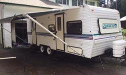 This rare 23ft. trailer has a triple bunk setup in the rear and a table that makes a queen in the front. Above the table also converts from shelves to a bed for light people. It has the standard three way fridge, gas oven stove combo, gas electric hot