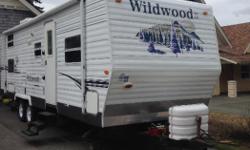 2007 Wildwood LE by Forest River. 27' trailer with a large 12' slide out. Northwest Edition (upgraded insulation, insulated floors, reinforced roof etc) "Master bedroom" in front with bunks at the back. Couch and dinette also convert to beds. A/C,