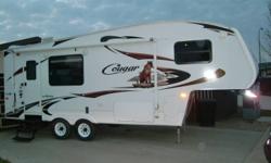 For Sale: 2009 Cougar fifth wheel 245 RKS. This trailer was bought new from Lardners Trailers. Sleep 6, standup shower, microwave, stove, fridge, A/C and flat screen TV. Queen bed tinted window and day and night shades. Fibre glass outside walls, large