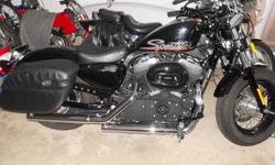Newly introduced balcked out Sportster 48.  Excellent condition.  Many add ons, all Harley Davidson.  Vance and Hines straight shot pipes, as well as hard leather bags and a detachable HD windshield for cooler rides.  Bike is still under extended