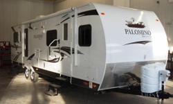 This travel trailer features a read bedroom with a queen bed slide. Large clothing and pantry storage allows for extended camping trips. The front living space is separated by an enclosed bathroom with a large corner shower. The 2011 Palomino Travel