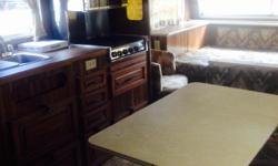 1979 Trailer, very Roomy. Sleeps up to 5. Double size bed up front that easily changes back up into couch, dining table that converts to bed as well as fold down cupboard above double that can be a bed. Fridge works, Propane oven and stove works and
