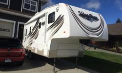 2010 26' Wind River 235RKS fifth wheel by Outdoors RV. In very good condition. Power jacks, power awning, tv, stereo, A/C, gas/electric hot water, large corner shower with bath, ceiling fan in kitchen, large variable speed fans in roof vents. Deep slide