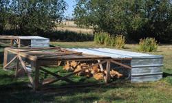 Two Portable chicken tractors Design by Joel Salatin. I built them this year. they are 10' X 12' with 6' covered in tin. If you always keep the tin facing North when you move them you can let broilers live in them till Butchering time from 14 days old. I
