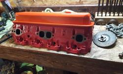 Cleaned up cylinder heads. New valve seals. Lapped the valves. Two tone paint. Por engine red heads. Chevrolet orange valve covers. Ready to bolt on. Also have quadrajet cleaned and painted manifold for the heads. 75 bucks. And a timing cover. 25 bucks.