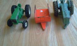 3 metal farm toys including tractors and wagon . sold as a set.  call 604 858 6955