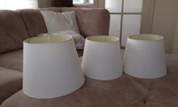 3 white lampshades never used. $15 for all three.
