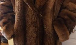 If the item is listed it is still for sale. It is removed immediately when sold. This stylish vintage fur coat is thick and comfy with a large collar. The sleeves are cuffed and can be lengthened or shortened to desired length. The coat is about a size