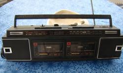 Older Lloyd's AM/FM radio with cassette player/recorder in good working condition. Uses batteries or plugs into outlet.