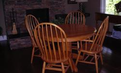 Amish oak dining table and 4 chairs ( 2 with arms). measures 48 round without leaves. measures 72 long with 2 leaves. Table is great shape.