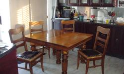 Antique 5 legged table and 4 chairs with leather seats  comes with one leaf.Square in shape  $700.00