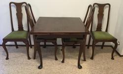 Square table with four high back chairs. Measures 36" x 36" extended 36" x 60"
