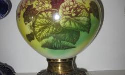 The lamp is 19 1/2" tall to the top of the globe. The lamp alone is 12" to the top of the burner. The base is brass & has beautiful flowers on front & back. The only others I've seen like this one are in the Maple Creek museum. It is in ex. cond. no chips
