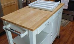 This efficient Real Simple Rolling Kitchen Island packs in the features to make food prep easy and convenient. Great for small spaces, this kitchen island has a cutting top, comes with locking wheels, removable wine rack and towel/push handle. 21.5" w x