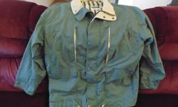 Bahama Men's lined jacket. Vented. Zip front, with snaps. Bottom drawstring to keep the cool air out. 2 front large snapped pockets and two zippered breast pocket; and one breast pocket inside. Adjustable cuff size. Hunter green with beige collar. Machine