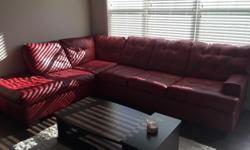 Large sectional that comes in 2 pieces (attached). Fake leather, cherry red, has big/nice very dark brown bases under each corner. Bought in 2013 and paid $1500. Has a bit of wear and tear as you will see from the pictures; 2 cushions are a bit more used