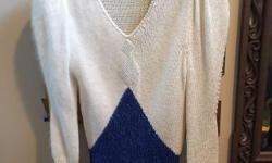 If you are a slim small person and like the CLASSIC RETRO look this sweater is for you. Size XS. WINTER WHITE Rayon, acrylic, wool, angora Rabbit hair. One sleeve and half body has Angora. Neckline and front embellished with Rhinestones. Blue with silver
