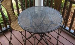 2 all weather rattan chairs with metal frame and 1 black metal table. The table folds up and the chairs stack, handy if you don't have a lot of space or extra guests show up.