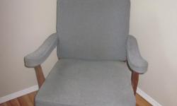 Comfy blue fabric and wood chair. Fabric is a little faded but otherwise in good condition.