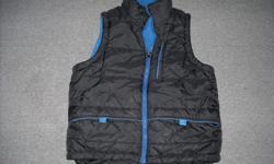 Boy's reversible quilted black vest with royal blue lining "GETAWAY" size S/P approx. 10/12,(boy's) 100% nylon shell with 100 % polyester nylon lining, velcro pockets, thick, quilted fabric, zippered pocket on upper left side. Good condition, no rips or