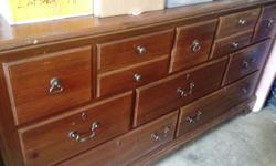 Brown Solid wood dresser measures 64"L x 18"d x 34 Â¼"H. Dresser has ten assorted size drawers. 9 of them slide great; one is a little tighter. The piece has a number of scratches, but is otherwise fully functional. Ideal for someone who loves to restore