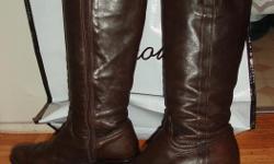 Browns Couture from browns on Robson, butter soft chocolate brown leather tall zipper boots. has gold lockets on outer side of the boots. low heel, semi pointed toe and will stretch at top of the calf if needed. come with the dust bag and shopping bag