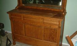 We have a 100 year plus old Nova Scotian Buffet in Solid Oak , Barley twist/ quarter sawn/beveled mirror and wooden casters.