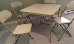 Metal card table with four chairs. Solid and in good working condition.