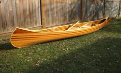 Redbird cedar strip canoe. 17' 6" long x 33" beam. beautiful example of Ted Moores design the redbird. used once and garage kept. comes with stand and 2 paddles.