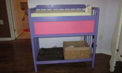 change table painted purple and pink. one drawer with lots of room for diapers and wipes and a lower shelf for additional storage. Change pad and cover included.