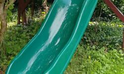 For sale: Green children's slide that attaches to playhouse. Approx. 6 feet high and 8 feet long; wavy. Good condition.