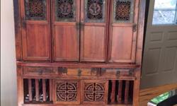 Beautiful carved and decorated cabinet. Upper has four carved doors with inlaid mother of pearl. Middle is three drawers. Lower is two shelves with carved and decorated sliding drawers. Measurements H 63" W 41" D 21"