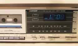 Used vintage Citizen clock radio/cassette stereo model JCR 877.
Everything works. The top has one small surface spot which melted slightly, and this is visible in the photo of the top.
Cassette player has record function. Radio is AM/FM. Individual left