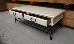 Pretty, solid wood and wrought iron coffee table with two drawers
Freshly refinished and painted in a soft crÃ¨me colour
Measures 46 1/2 long x 23 1/4 inches wide x18 1/2 tall
Located in Chemainus