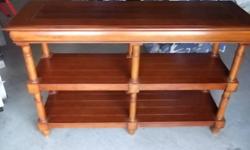 Console table is largely solid wood, only bottom two shelves are not. 3 months old, excellent condition. 18"W x 54"W x 34"H