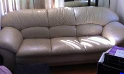 Real leather. Color beige. Couch is 6' 9".Couch in good condition, slight wear on one cushion. Matching Arm chair in excellent condition looks brand new. Originally paid over 4000.00 for set. The picture of armchair looks different color because in