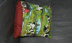 Cow scene on the front, burgundy backing. The blanket that turns into a pillow.