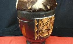 Cow skin top and carved 14.5 inch tall X 10 inch djembe drum, inventory #141895-1. Price of $139 includes all taxes. PLEASE REFER TO INVENTORY #141895-1 WHEN INQUIRING. We also have more items for sale at The Bay Street Broker located on the corner of Bay