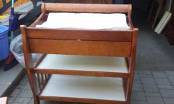 Solid 4 year old Sears crib set. Medium to dark coloured wood. Good condition. Some scratches. Crib is apart and has all pieces. Crib has a drawer on wheels that store under crib. Comes with excellent condition crib mattress. Change table has one drawer