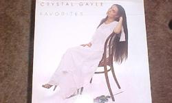 THIS RECORD ALBUM, FAVORITES, BY CRYSTAL GAYLE WAS RELEASED IN 1979 BY UNITED ARTISTS. ITS NUMBER IS LOO-1034. SOME OF THE FEATURED SONGS ARE DON'T TREAT ME LIKE A STRANGER. RIGHT IN THE PALM OF YOUR HAND AND HEART MENDER. BOTH THE SLEAVE AND RECORD ARE