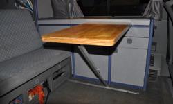 This table has been custom made to replace a missing OEM table that works with the Eurovan Westfalia Camper.
The table leg telescopes down, and folds down so that it can be stowed under the seat.
I am selling it for what it cost me to have the leg
