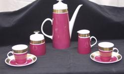 This is a fine Porcelain Vintage
Lichte (East Germany) set.
 
The rich rasberry and gold colours are very striking.
 The set has a Classic slender Art Deco shape
 
The coffeepot is 8 1/4" high
The cream and sugar are 3 1/2" high
 
In perfect condition,